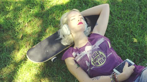 young blond woman relaxing listening to music