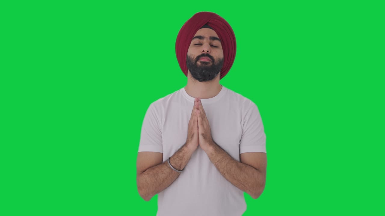 Religious Sikh Indian man praying to God Green screen