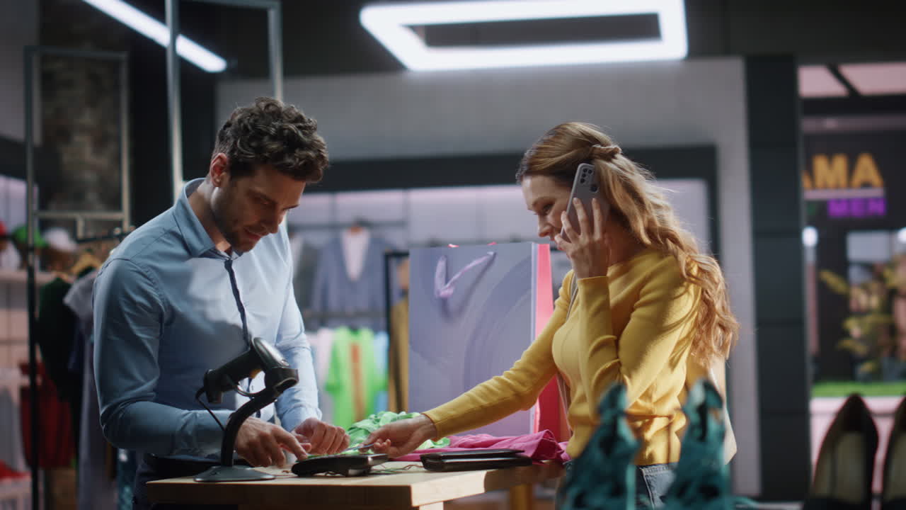 Happy shopaholic paying terminal credit card buy clothes cashier counter closeup