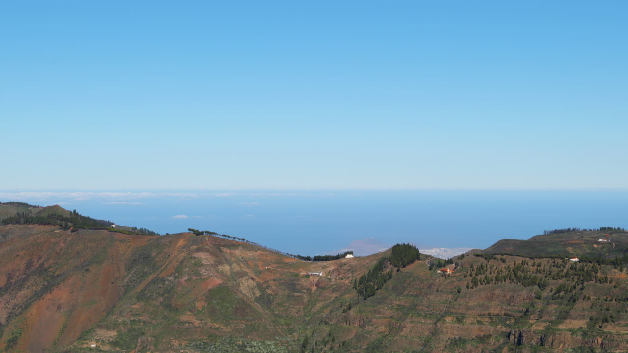 Coastline view from the road and surrounding nature during wind where trees and strong waves move at sea Canary island 4k slow motion capture at 60fps