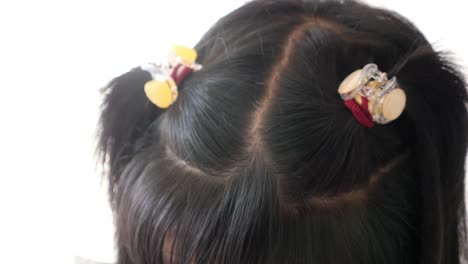 child's hair with hair clips