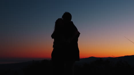 silhouette couple hug at sunset for valentine's day