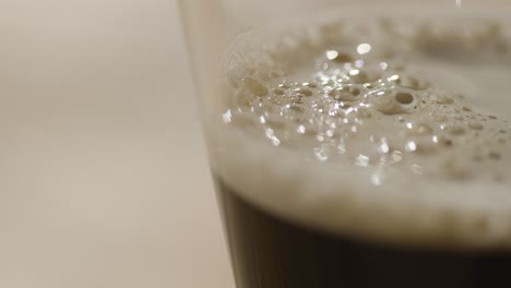 close up of pint of irish stout in glass to celebrate st patricks day 1