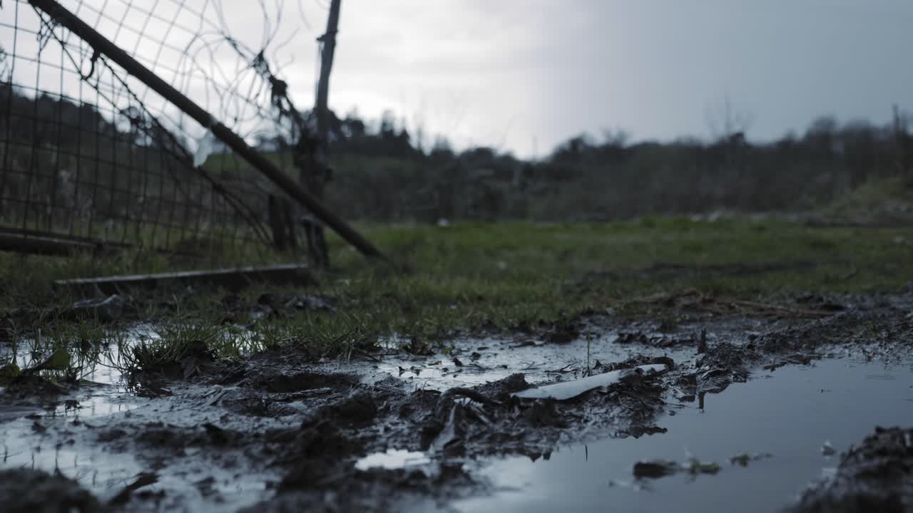 The Destroyed Gate Standing On A Muddy Ground Of A Plain Fields In Northern Ireland. -wide shot