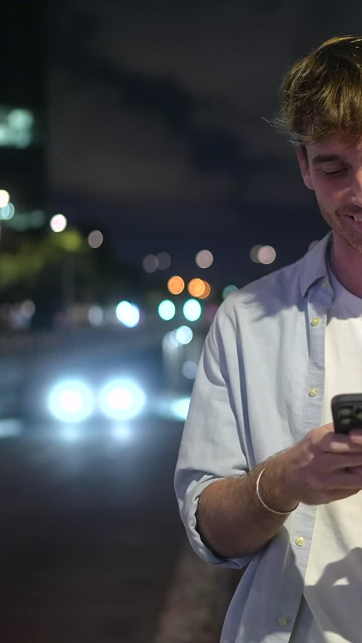 Man using phone at night in the city