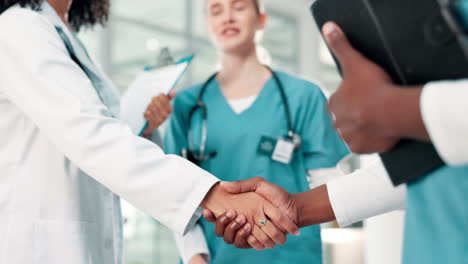doctors shaking hands in a hospital setting