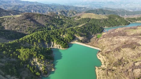 aerial shot of mountain river closed up with a dam