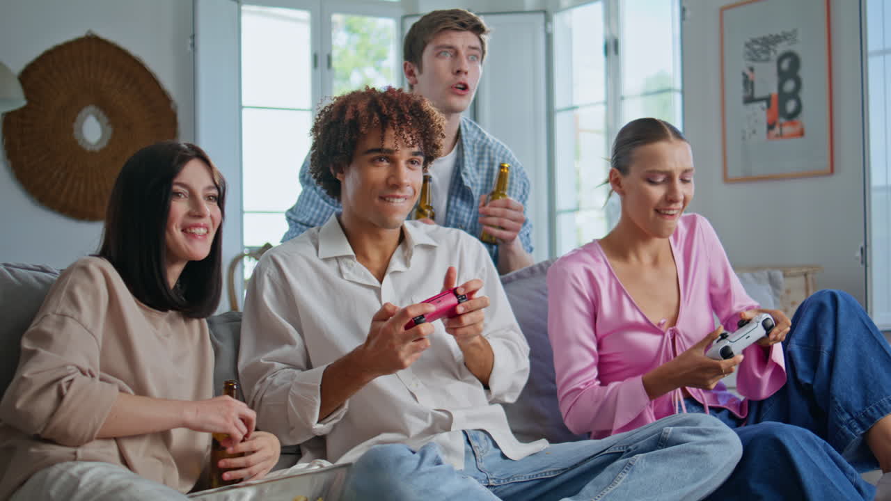 Gambling people playing gamepads at friendly gathering closeup. Friends hangout