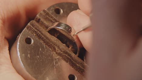 close-up of a goldsmith working on a ring