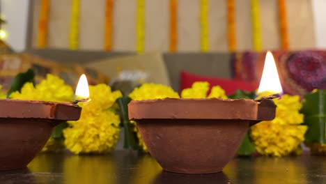 slow tracking shot of  diyas (oil lamps) from left to right