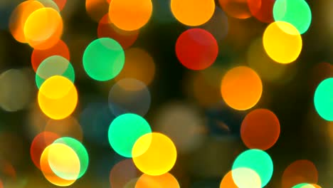 christmas tree with colorful bokeh and christmas lights..christmas and new year decoration. abstract bokeh holiday background. blinking garland. christmas lights twinkling.