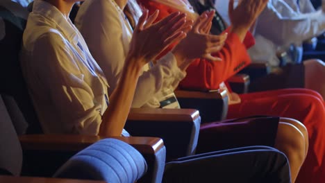 business people applauding while sitting on seats in auditorium 4k