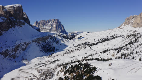 dolomite mountains covered in winter snow with blue sky background in northeast italy