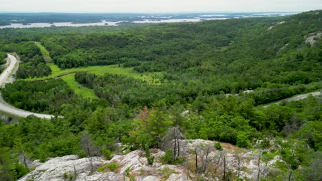 Aerial-reveal-over-mountaintop-lookout-to-lake-huron