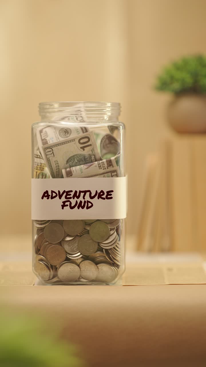 VERTICAL VIDEO OF PERSON SAVING MONEY FOR ADVENTURE FUND