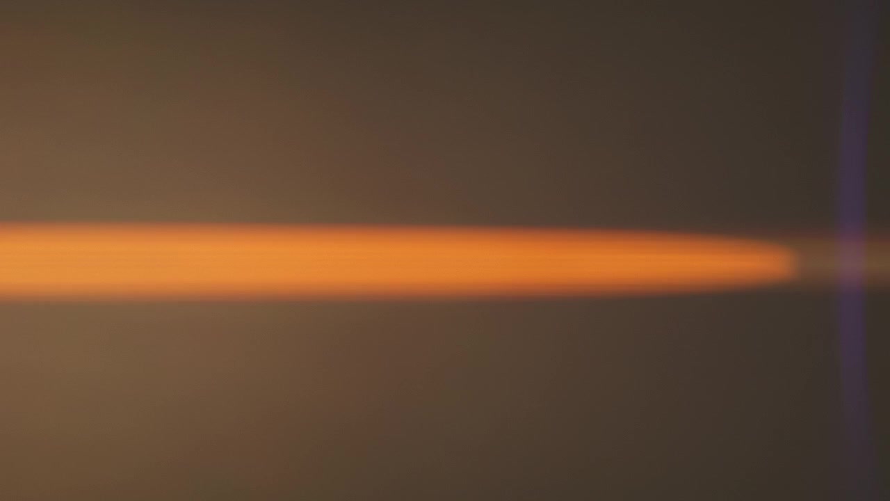 Bright golden anamorphic lens flares with warm horizontal light