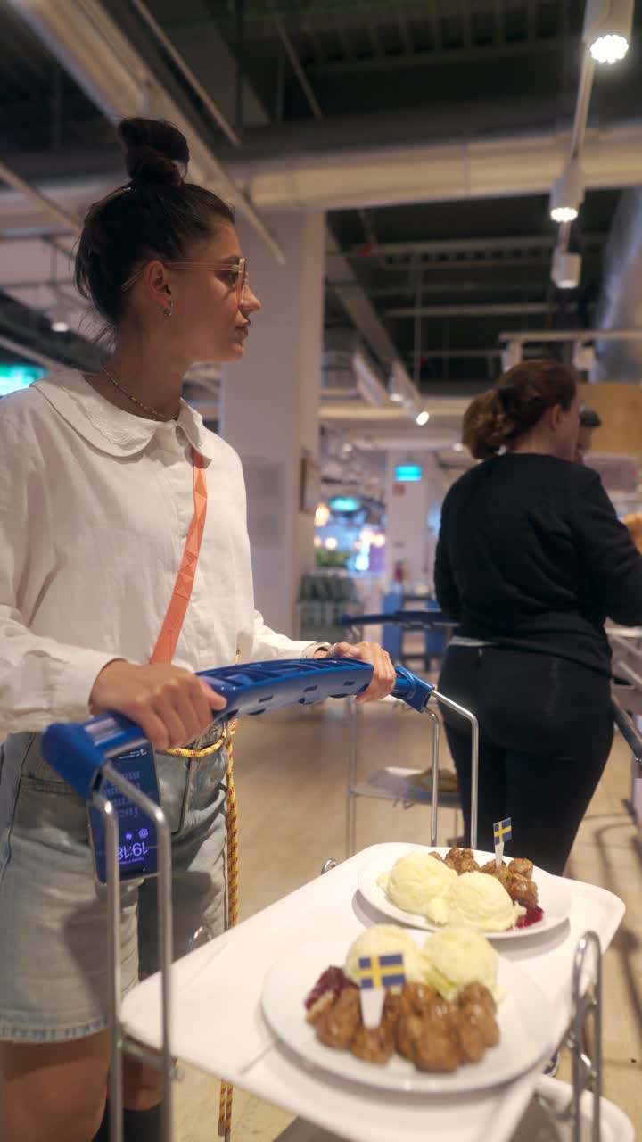 Woman Serving Food at a Swedish Restaurant