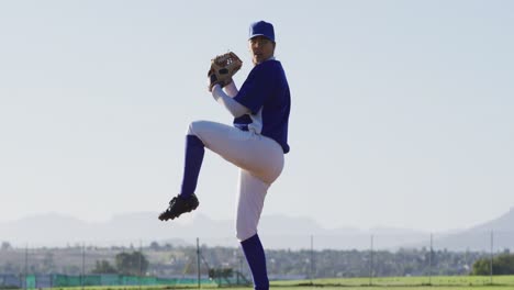 caucasian female baseball player wearing glasses pitching ball on baseball field