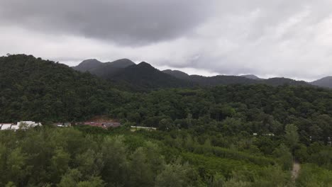 Ascending-aerial-view-of-mountain-range-on-cloudy-day