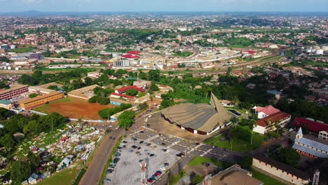 Aerial-overview-of-the-Basilica-of-Mary-Queen-of-Apostles,-in-Cameroon---pull-back,-drone-shot