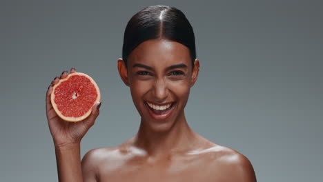 Woman,-face-and-beauty-with-grapefruit