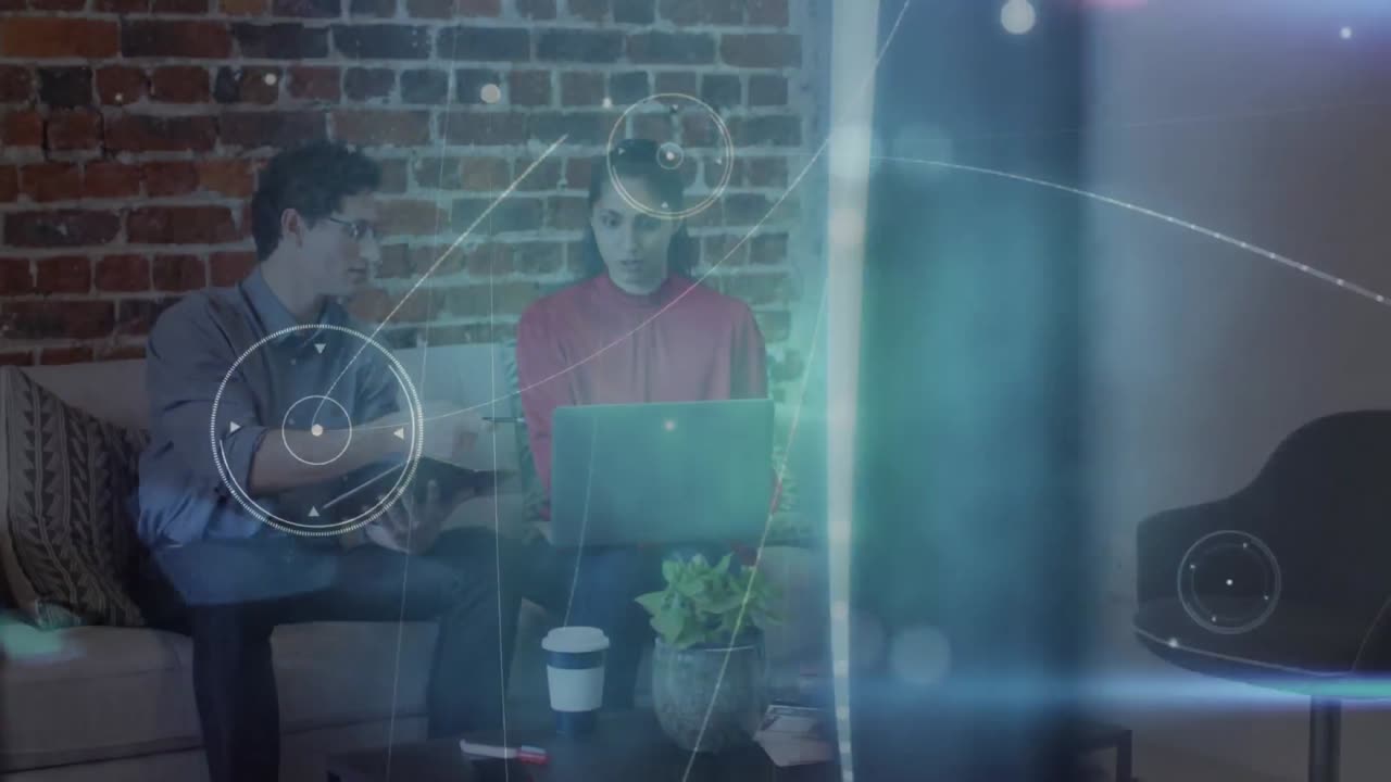 Animation of connections and data processing over male and female colleague working on laptop