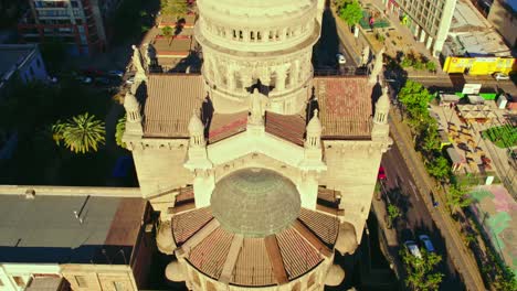 Dolly-out-of-the-statues-and-the-main-dome-of-the-Sacramentinos-church-illuminated-by-the-day-of-the-sun,-Santiago-Chile