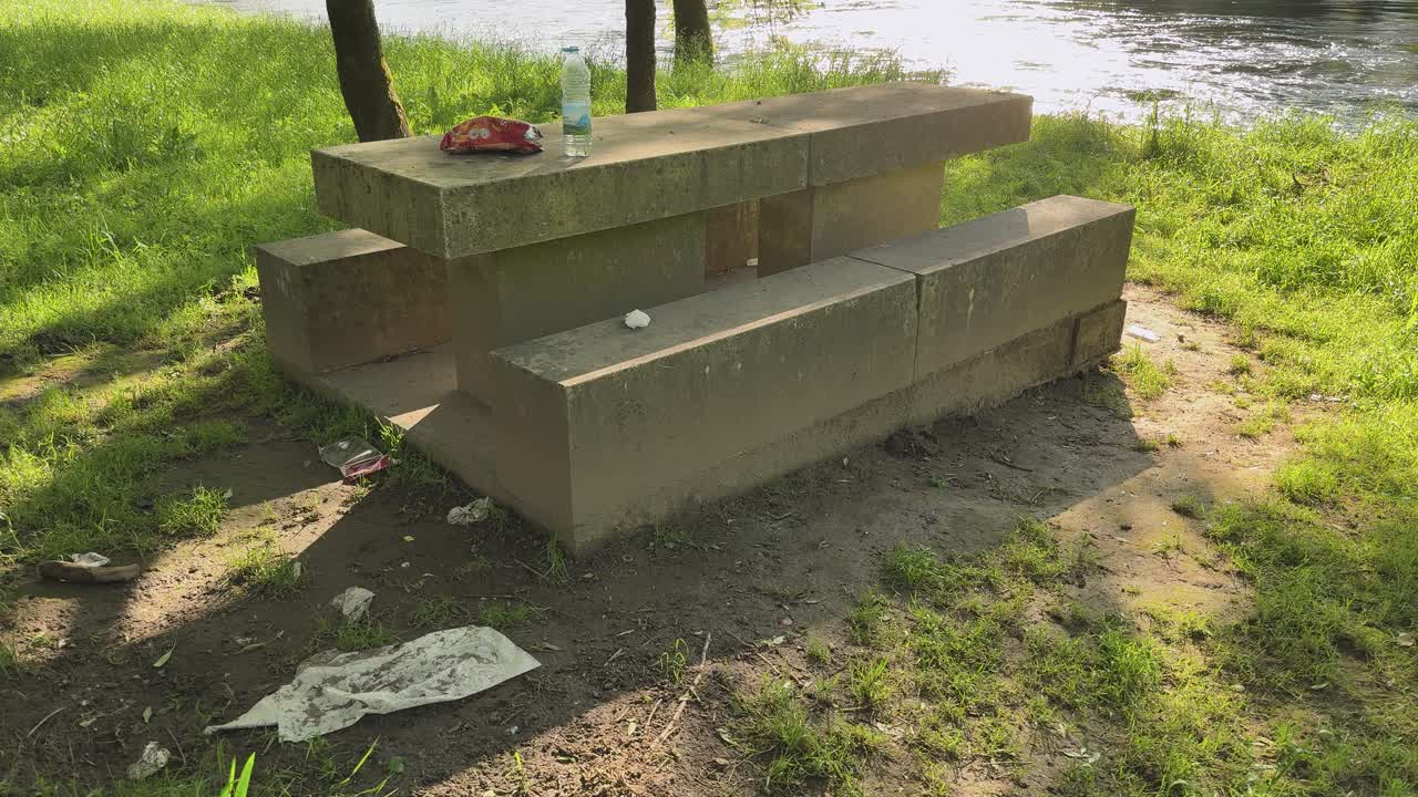 A dirty barbecue area is left after the people went home.