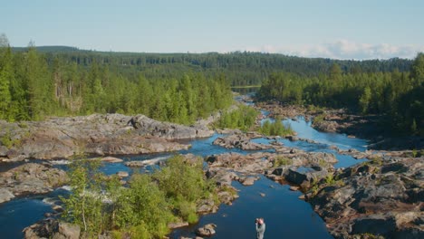 flying over rapids and a waterfall during a warm sunny summer evening