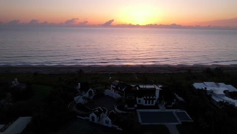 amazing waterfront home on beach at sunrise overlooking ocean real estate sale