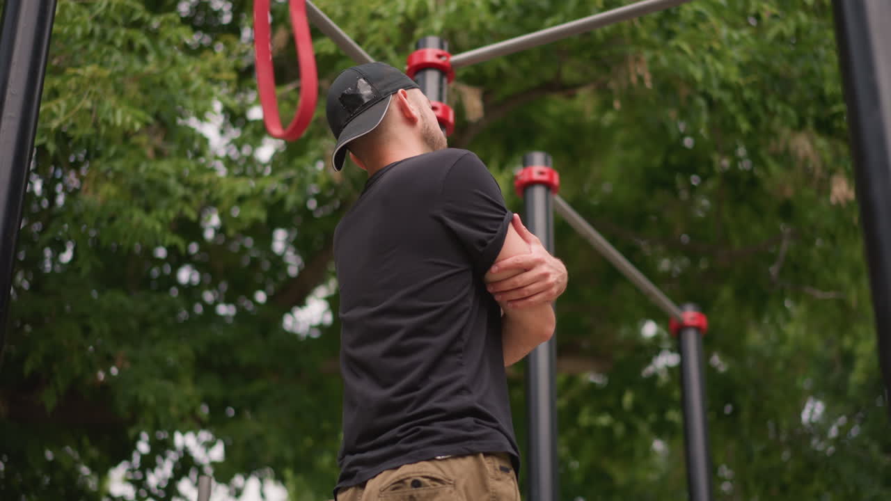 Man Rests Outdoors, Individual Takes Moment To Recover Outside, Person Pauses To Relax Following Band Performance Outdoors, Man Takes Brief Break To Recover After Playing Music Outdoors In Park