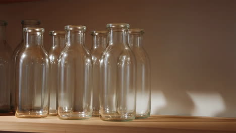 row of empty glass bottles on a shelf