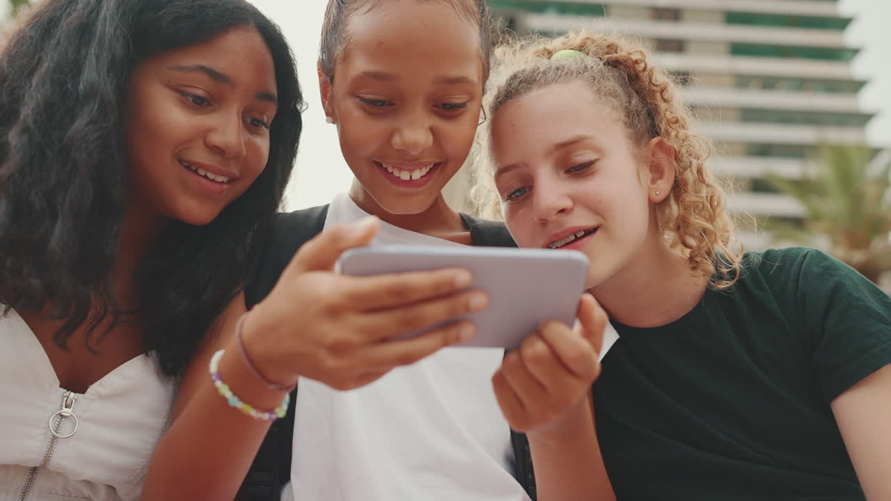 Teenage Friends Enjoying Mobile Phone Together