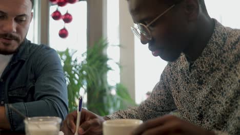 Freelancers-drinking-coffee-and-working-in-cafe