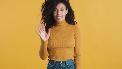 African-american-smiling-woman-over-orange-background.