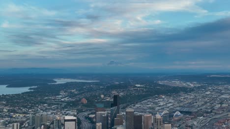 drone shot of seattle's skyscrapers and how they ascend towards mount rainier in the distance