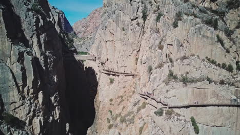 narrow bridge between two steep mountains over the canyon