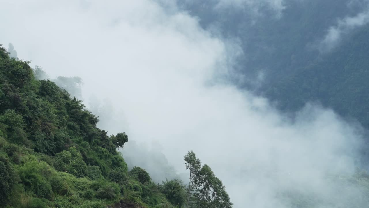 Clouds in a Valley in the Mountains, Himalayas Valley Filled with Clouds in Nepal