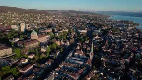 Establisher-aerial-view-of-Zurich-cityscape-oldtown-at-sunset,-circle-pan