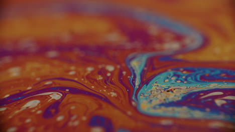 blue and orange liquid moving and forming abstract forms and patterns