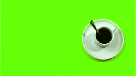 Detener-El-Movimiento-En-Un-Fondo-Verde-Del-Reloj-De-Café-Donde-Gira-La-Cuchara-De-Una-Taza-De-Café-Y-Al-Final-El-Café-Desaparece