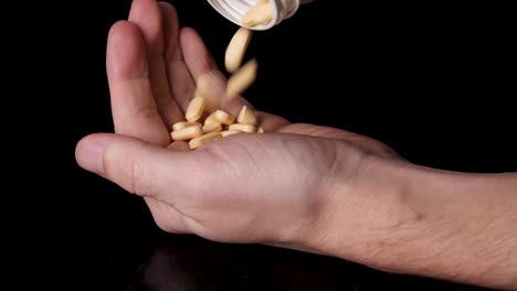 medication drug pills being emptied into a hand