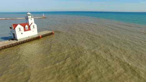 flyover of scenic lighthouse on lake michigan