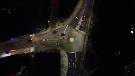 clockwise-birds-eye-view-spin-of-the-main-round-about-in-the-center-of-todmorden-that-located-in-west-Yorkshire,-this-shot-is-filmed-at-night-,-with-a-few-slow-moving-cars