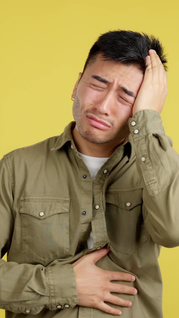 Man experiencing headache and stomach pain