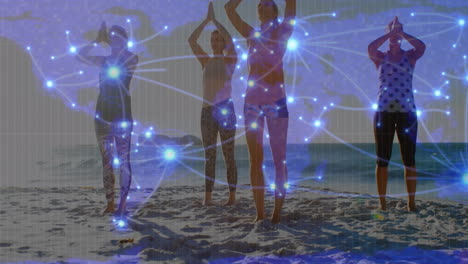 animation of glowing global network over female friends doing yoga on sunny beach