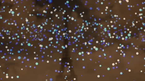 animation of blue and white christmas flickering spots over eiffel tower in background