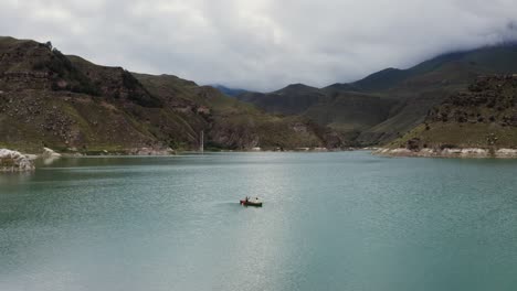 people canoeing on a mountain lake