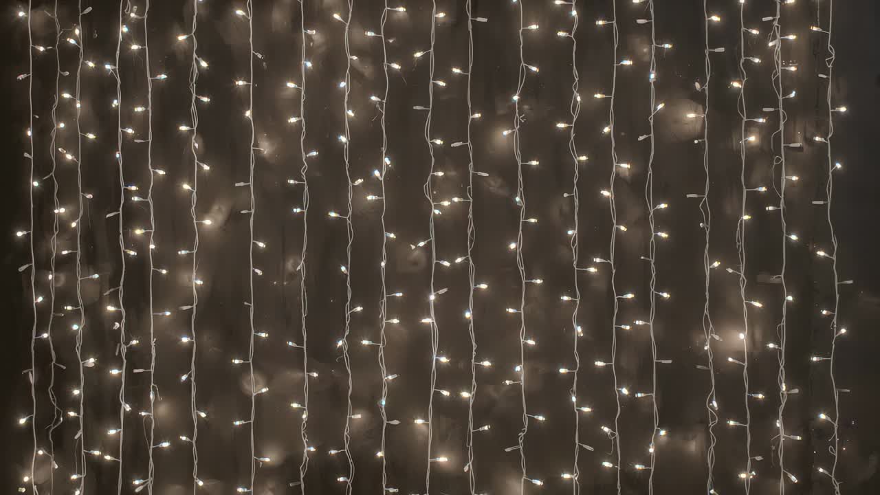 Glødende gardin af varme LED-stringlys, der blinker i et hjørne af studiet og skaber en hyggelig stemning