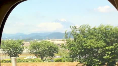 farmland in the foreground with snow capped mt fuji in the background